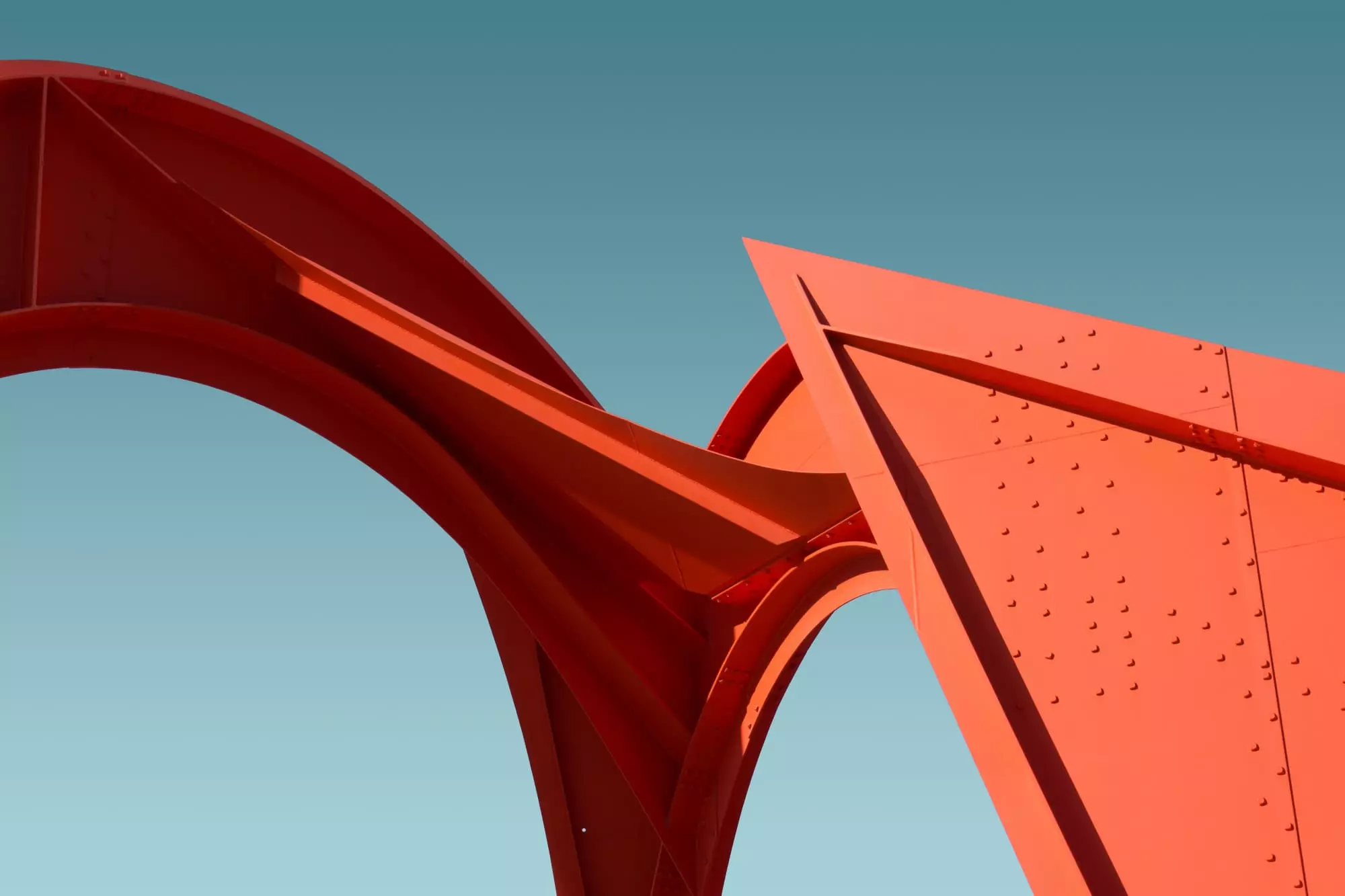 low-angle-of-a-metal-red-structure-under-the-clear-blue-sky