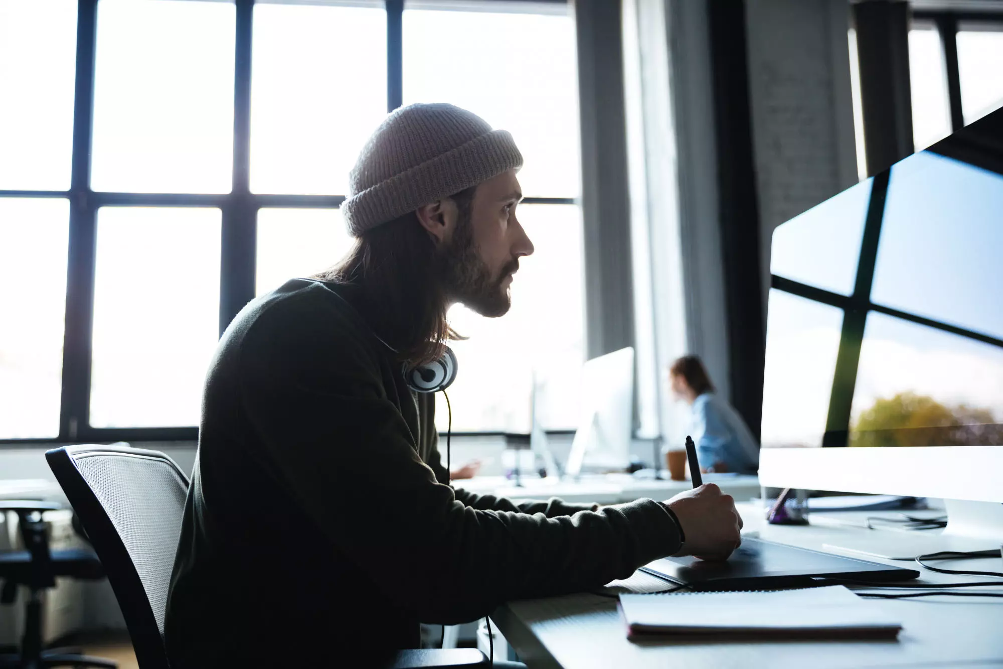 man-work-in-office-using-computer-looking-aside