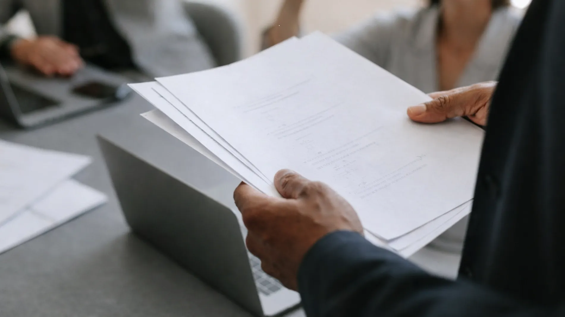 Team reviewing an exterior architectural rendering brief and project documents before 3D visualization production