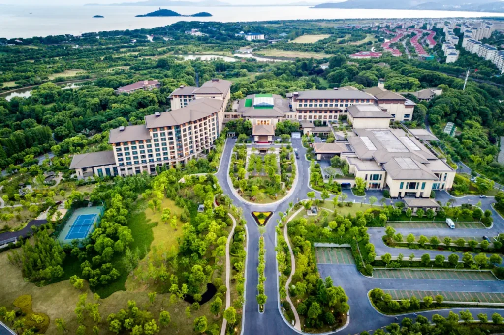 Aerial drone view of large residential complex and landscape, used for real estate CGI and planning visuals.