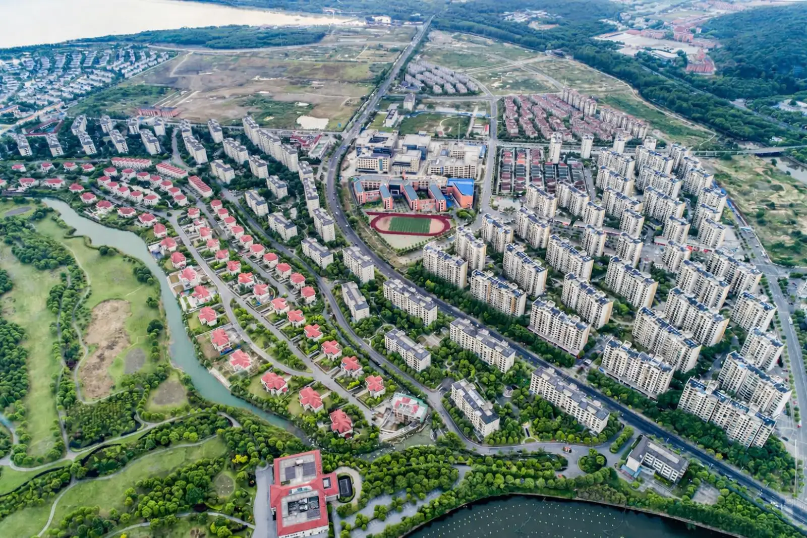 High-altitude drone view of urban residential district and roads